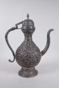 An Indo-Persian white metal coffee pot with repousse hand tooled decoration of birds amongst