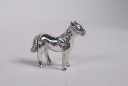 A miniature silver figure of a horse, 1"