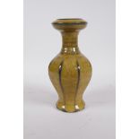 A Chinese mustard yellow crackle glazed pottery vase of ribbed form, impressed 4 character mark to