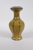 A Chinese mustard yellow crackle glazed pottery vase of ribbed form, impressed 4 character mark to