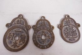 Three Chinese bronze graduated pendants decorated with calligraphy, largest 2¾" long