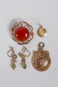 A 9ct gold brooch set with a garnet, two 9ct gold pendants and a pair of yellow metal drop earring