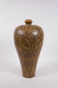 A Cizhou green glazed ceramic vase, with incised decoration of a dancing boy, 13" high
