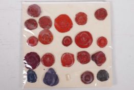 A collection of antique wax seals mounted on paper