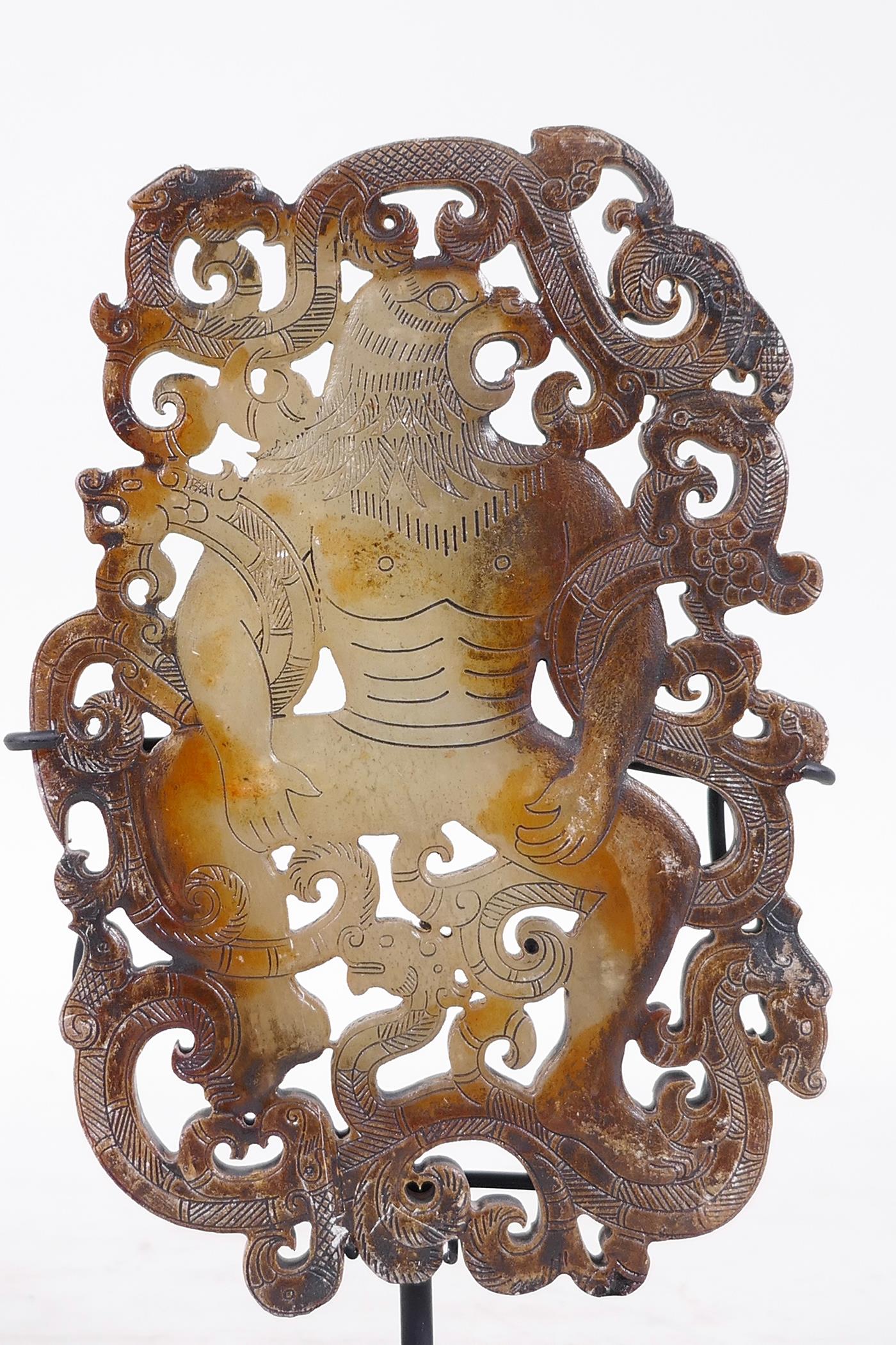 A Chinese pierced jade ornament, carved in the form of a bird headed man entwined with dragons, on a - Image 2 of 3