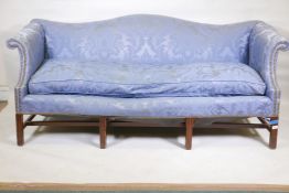 A Chippendale style camel back settee with scroll arms and shaped front, raised on square moulded