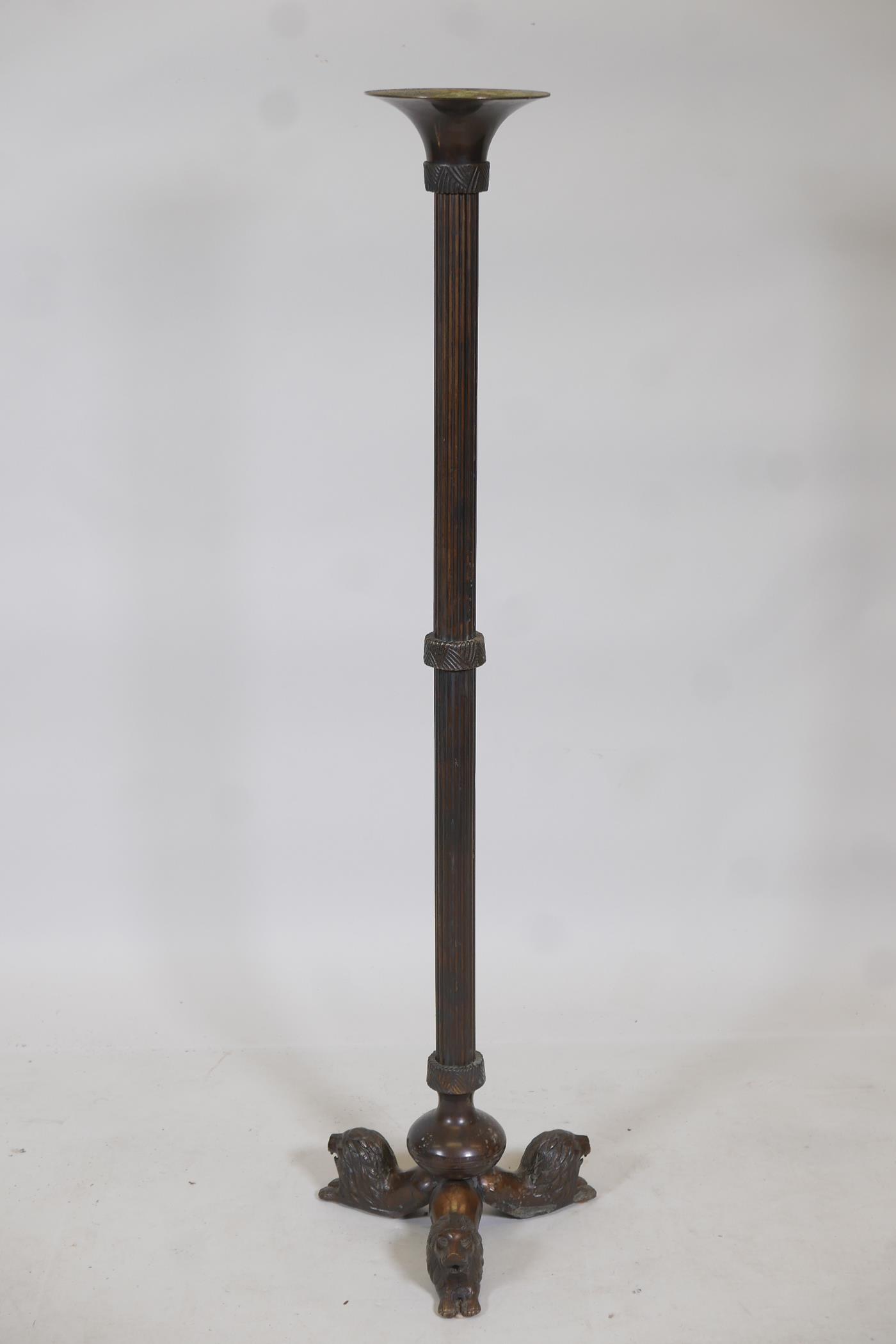 A bronze torchere, with reeded columns and lion supports, 41" high