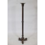 A bronze torchere, with reeded columns and lion supports, 41" high