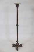 A bronze torchere, with reeded columns and lion supports, 41" high