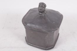 A Continental lead tobacco box with inner lid, the handle to the lid modelled as a human head, 4"