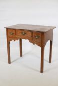 A late C18th/early C19th oak lowboy, with three cockbeaded drawers, original brass plate handles and