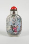 A Chinese reverse decorated glass snuff bottle depicting a sage riding a buffalo and a lakeside