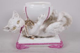 A C19th Continental porcelain figure of a playful cat with large ball (half ball lid missing and