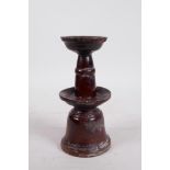 A C19th Chinese treacle glazed terracotta candlestick, 7" high, A/F