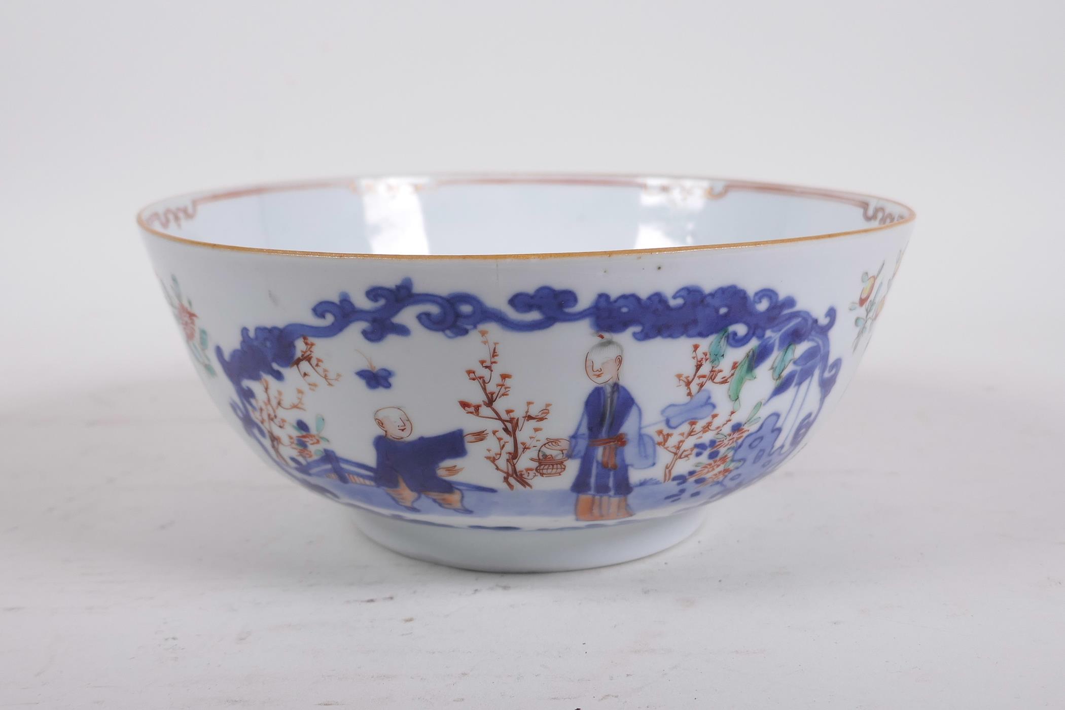 A C18th Chinese polychrome porcelain bowl decorated with figures in a landscape and flowers, 7½"