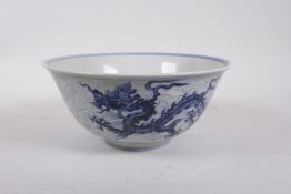 A Chinese Ming style porcelain bowl decorated with a dragon in flight, 6 character mark to base, 8½"
