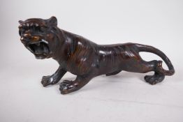 An Oriental bronze figure of a roaring tiger, 13" long