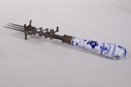 An antique porcelain handled meat fork with an unique scissor action/pusher, the porcelain handle