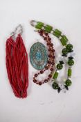 Three ethnic bead necklaces including coral, and a large oval lapis set pendant, 4" long