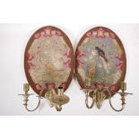 A pair of C19th two branch wall sconces with tapestry backs depicting a dog and bird in a tree,