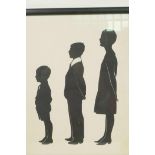 A cut paper silhouette of three figures, label verso, attributed to Hubert Leslie at West Pier