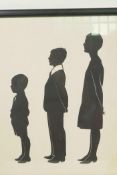 A cut paper silhouette of three figures, label verso, attributed to Hubert Leslie at West Pier