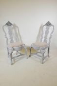 A pair of early C20th Gustavian style painted and distressed chairs, with carved details, 45" high