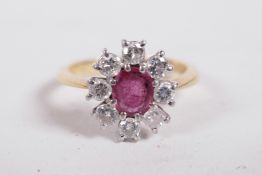 An 18ct gold set diamond and ruby cluster ring, size 'R'