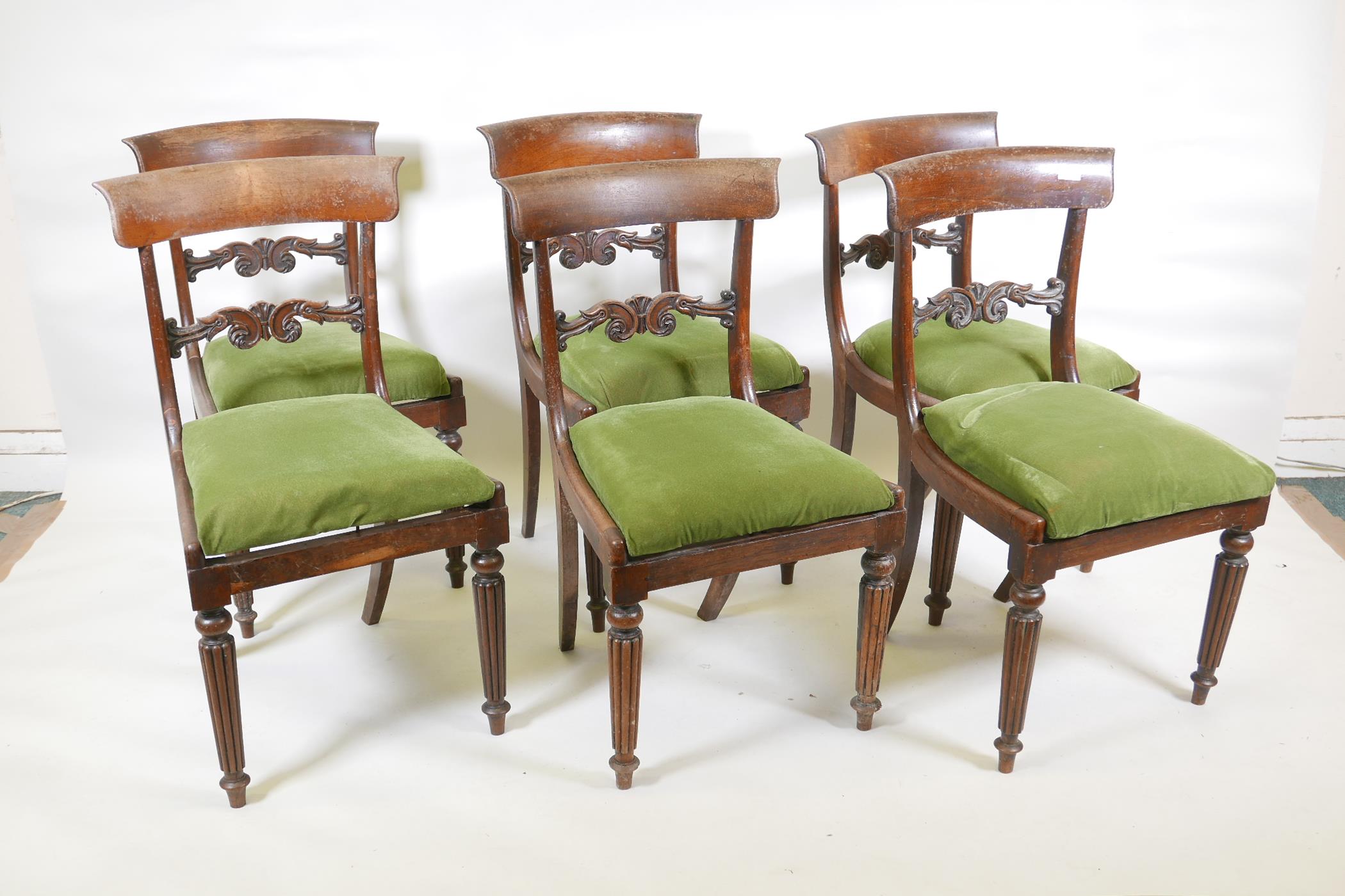 A set of six Regency/William IV rosewood dining chairs with carved back splats, stamped with maker's
