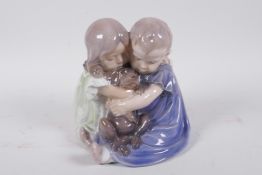 A Royal Copenhagen porcelain figure of two young children with a puppy, 6" high