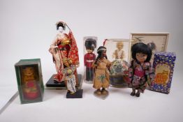 A collection of costume dolls from Japan, Thailand, North America etc and two boxed painted stacking