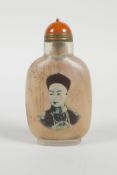 A Chinese reverse decorated glass snuff bottle depicting an emperor and a tree in blossom, 3½" high