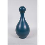 A Chinese dark green glazed porcelain garlic head shaped vase, impressed seal mark to base, 10½"