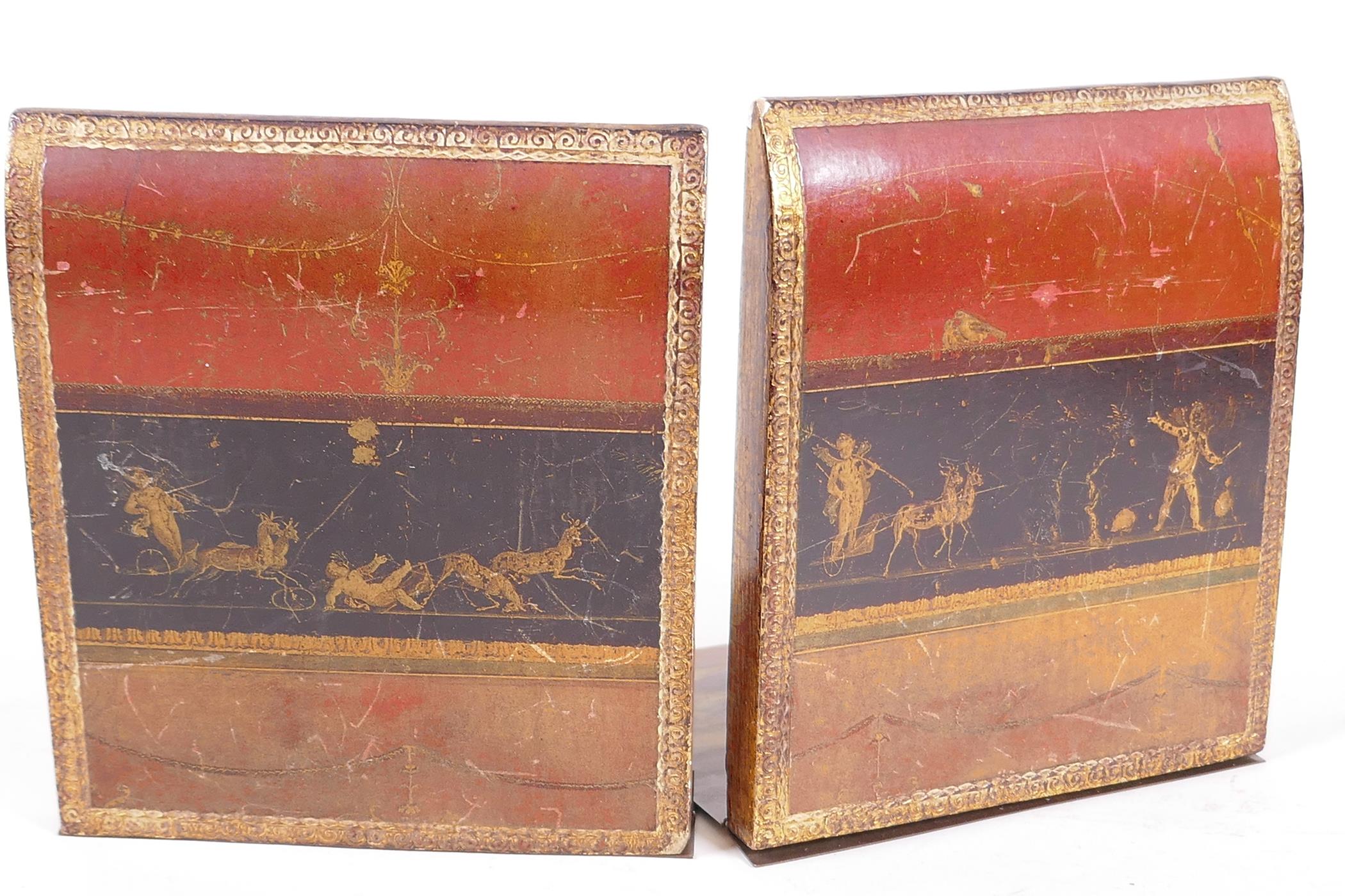 A pair of wood, leather and brass bookends, the wooden ends leather bound in the form of books