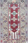 A Persian full pile multicolour ground wool carpet, the central panel with floral medallions on a