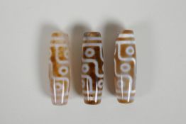 Three Tibetan Dzi beads, 2" long