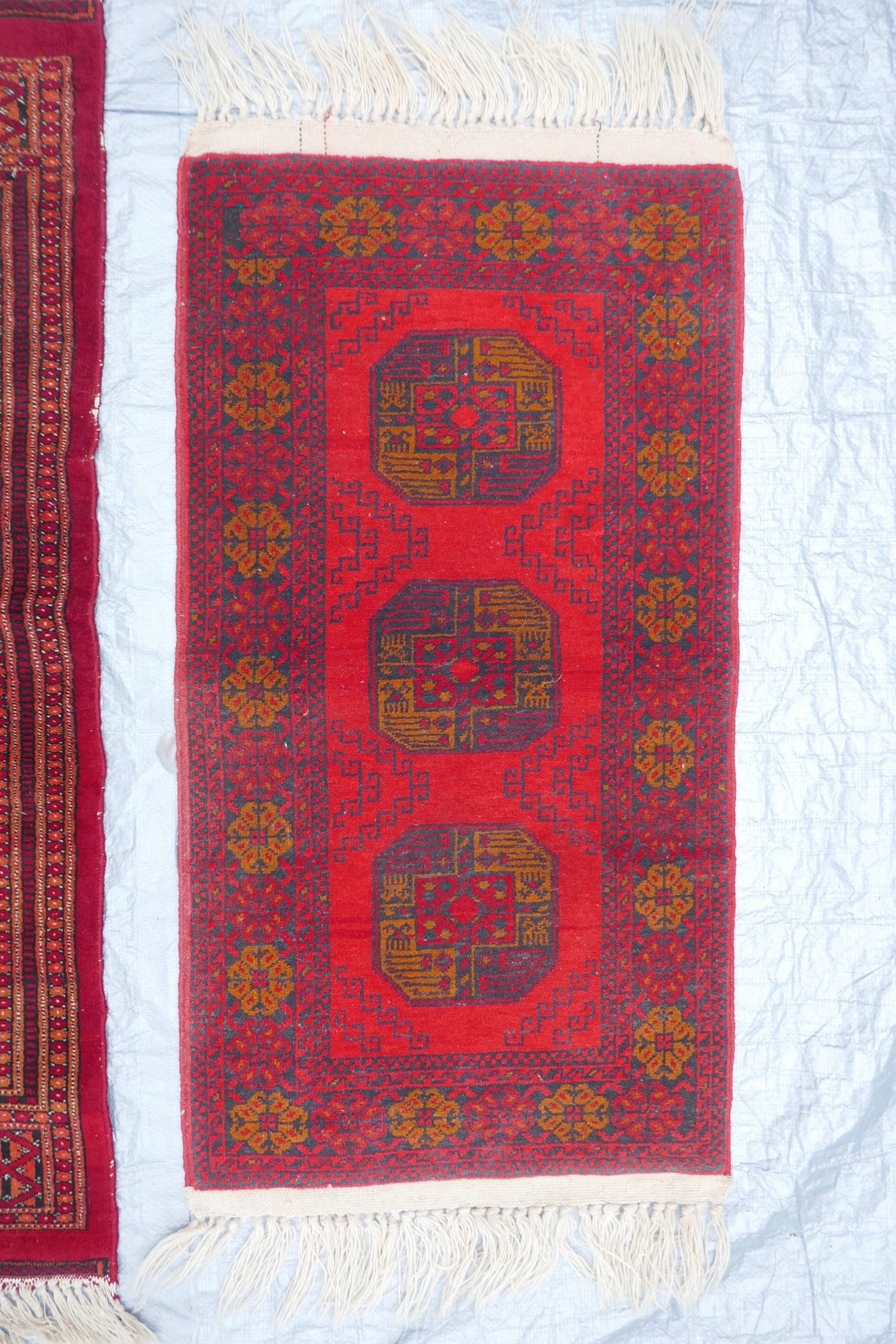 A red ground Turkmen wool rug with a Bokhara design on a cream field, 32" x 48", and another - Image 3 of 5