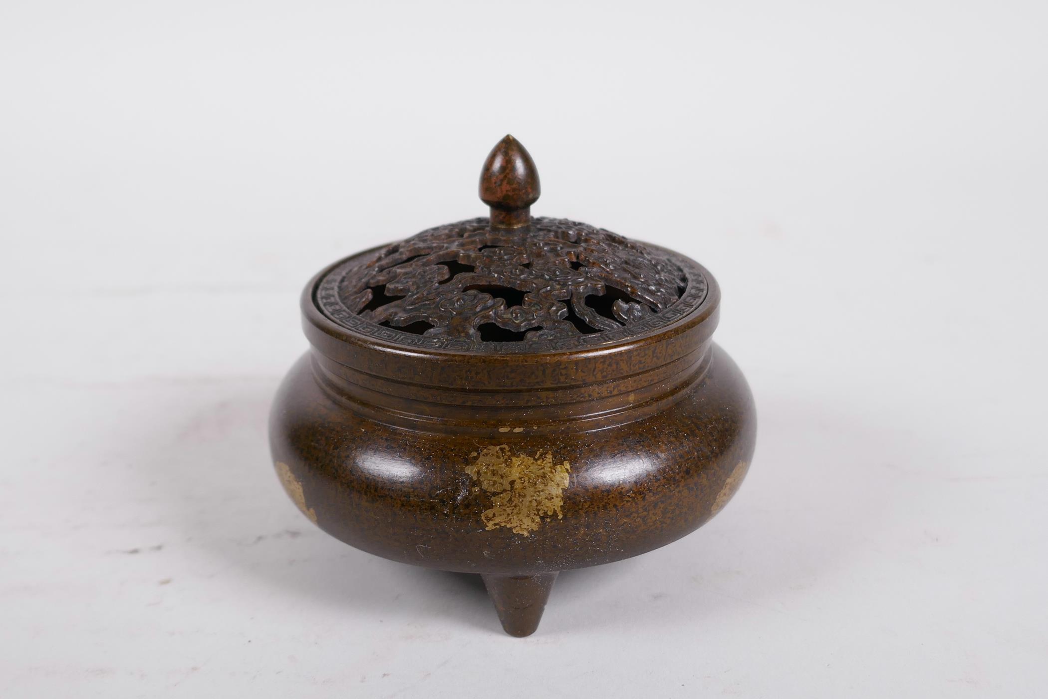 A Chinese bronze censer and cover on tripod supports, with gilt splash decoration, 6 character