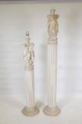 A painted plaster floor lamp, in the form of three putti supported upon a fluted column, 41" high,