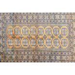 A Turkmen gold ground wool rug with a Bokhara design, 51" x 80"