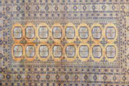 A Turkmen gold ground wool rug with a Bokhara design, 51" x 80"