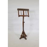 A stained beechwood music stand with mother of pearl inlay and painted decoration, raised on a