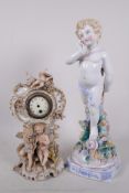 A Continental porcelain figure of a coy cherub, 14" and a Continental porcelain cherub decorated