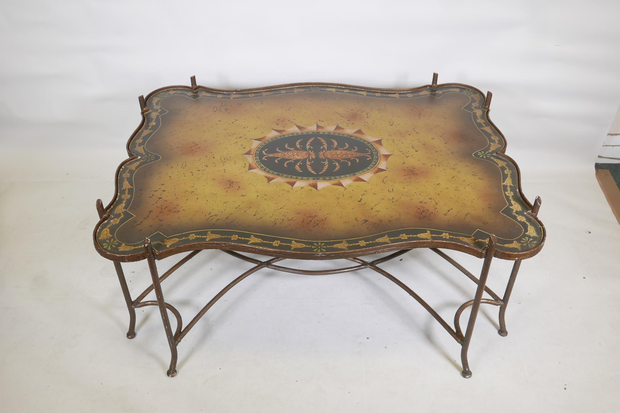 A painted metal framed low table, with hand painted shaped top, raised on sabre supports with - Image 2 of 3