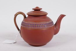 A redware ceramic teapot with raised enamel and gilt decoration, base impressed 19, 5" high