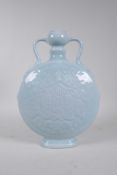 A Chinese blue glazed porcelain two handled moon flask with underglaze carp and symbol decoration,