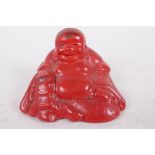 A Chinese cinnabar lacquer style figure of Buddha, 2" wide