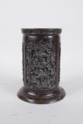 An C18/19th Oriental bronze brush pot with three panels decorated with a scrolling floral design,