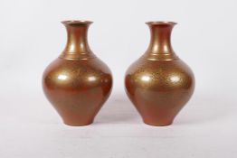A pair of Japanese lacquered brass vases, inscribed seal mark to base, 9" high