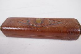 A C19th leather travelling sewing case with brass fittings, 8" long, containing button hooks etc